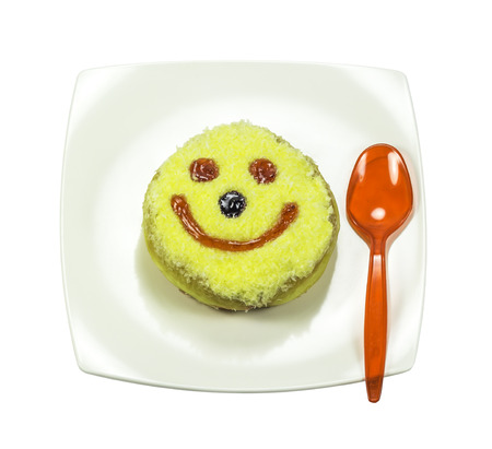 Donut in plate with red spoon isolated on white backgroundの写真素材