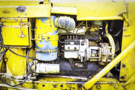 Old engine machine of the yellow tractorの写真素材