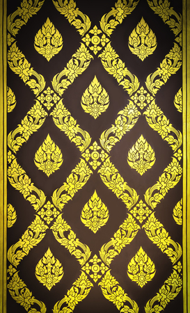 Ancient Thai golden painting on wooden doorの写真素材