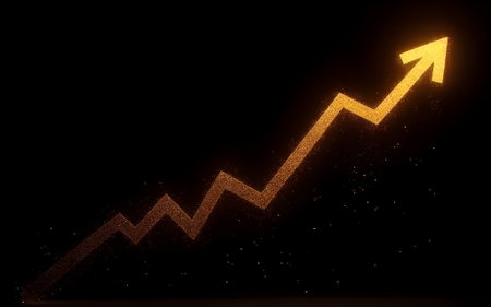 A radiant golden line graph, trending upwards in a wavy pattern, glows against a deep black background. Tiny sparkling particles are scattered around, resembling shimmering golden dust. This image effectively conveys concepts of success, business growth, increasing profits, financial progress, investment, stock market trends, and positive outlooks. It is ideal for designs requiring financial data visualization, analytics, inspiration, or a luxurious and powerful aesthetic.の写真素材