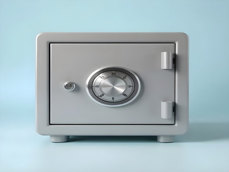 A clean, bright 3D rendering of a small, sturdy silver/gray metal safe. It features a prominent circular combination lock dial.の写真素材