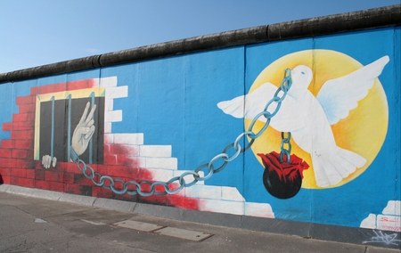 Berlin wall graffiti with a white dove representing peace and freedomのeditorial素材