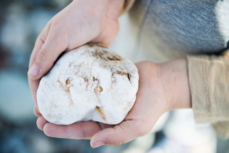 Girl playing with Sea Rock in Landudno, England, UKの写真素材