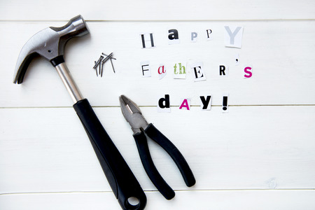 Happy Fathers Day Letters Cut out from Magazine and Tools On White Backgroundの写真素材