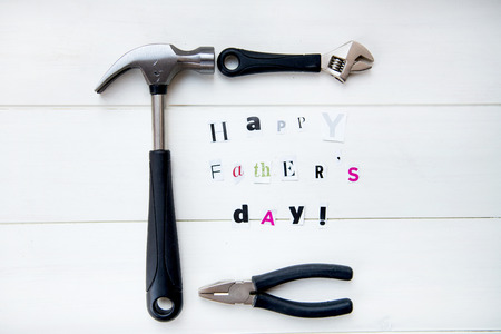 Happy Fathers Day Letters Cut out from Magazine and Tools On White Backgroundの写真素材