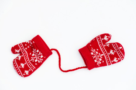 Christmas Red Knitted Mittens with Snowflake Motives on white backgroundの写真素材