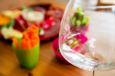 Empty Glass for Wine and Snacks on the Table in the Backgroundの写真素材