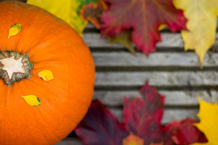 Close up of the Orange Pumpkin and Autumn Leaves on Wooden Background as Autumn Concept, Shallow DOF, Selective Focusの写真素材