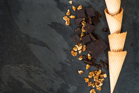 Walnuts, Chocolate and Waffle Cones on Dark Grunge Backgroundの写真素材