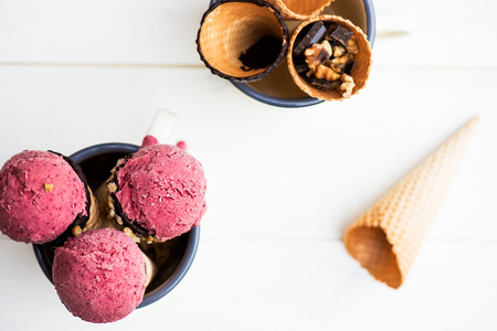 Homemade Fresh Healthy Ice Cream made from Berries with Waffle Cones on the Backgroundの写真素材