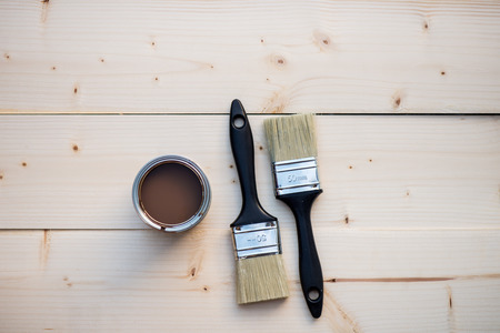 House Renovation, Brown Paint Can and Brushes on Wooden backgroundの写真素材