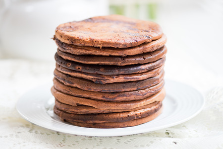 Stack of Homemade Chocolate Pancakes for Breakfast on White Backgroundの写真素材
