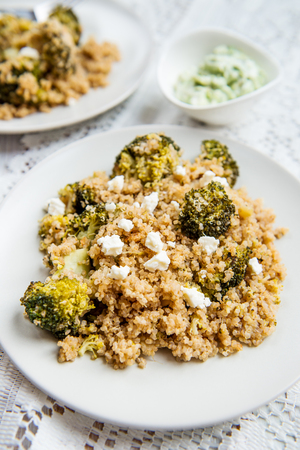 Warm Detox Salad from Quinoa, Broccolli and pieces of Goat Cheese ot topの写真素材