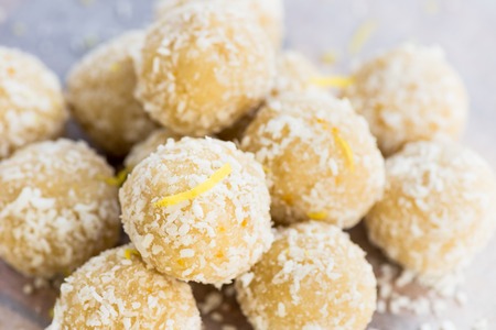 Homemade Raw Vegan Coconut and Lemon Truffles on White Background