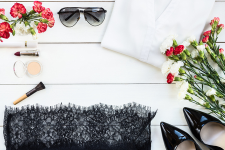 Woman Trendy Fashion Accessories such as Court Shoes, Silk Blouse, Lace Skirt, Necklace, Sunglasses, Make Up and Jewellery on White Wooden Background, Flat Lay, Top Viewの写真素材