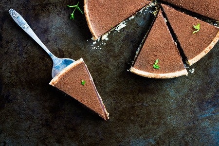 Slices of Salted Caramel andChocolate Tart on Dark Backgroundの写真素材