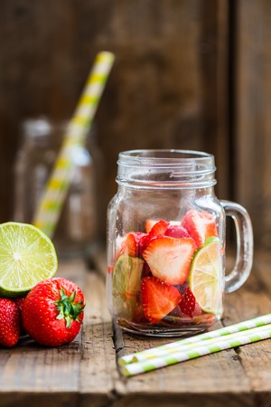Ingredients for Summer Slushies from Strawberries and Lime, on dark rustic backgroundの写真素材