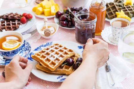 Table Set for Breakfast with different kinds of Healthy Waffles, Jams and Berriesの写真素材