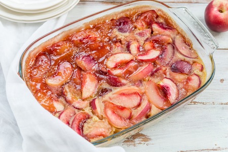 Homemade Nectarine Pie in a Glass Form on Light Wooden Backgroundの写真素材