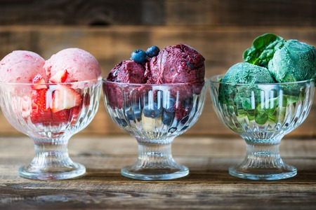 Different Homemade Vegan Nice Cream or Sorbet from Banana, Spinach, Strawberry, Blueberry. Wooden background, summer food concept.の写真素材