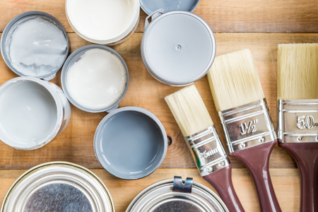 Preparation for the renovation of the Wooden Box with Brushes, and Open Cans of Different Paints, Varnish and Stainの写真素材