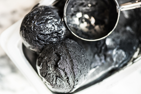 Scoops of Homemade Black Charcoal Coconut Ice Cream the Containerの写真素材