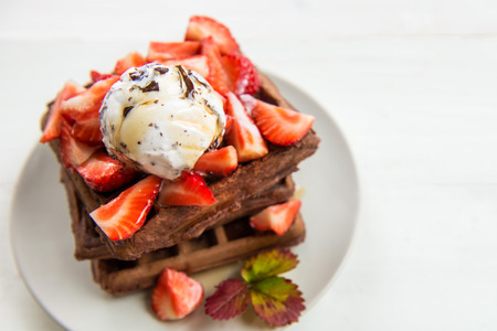 Homemade Chocolate Belgium Waffles with Strawberries, Vanilla Ice Cream and Maple Syrup, on the Light Backgroundの写真素材