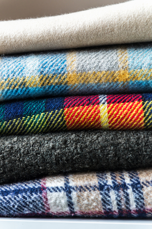 Stack of woolen checked blankets, autumn and winter concept