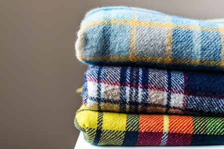 Stack of woolen checked blankets, autumn and winter conceptの写真素材