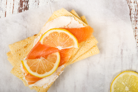 Healthy Snack from Gluten Free Crispbread, Soft Cream Cheese, Smoked Salmon and Lemonの写真素材