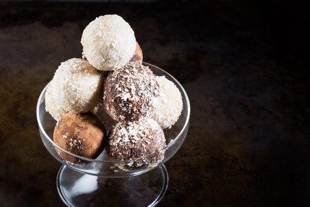 Various Homemade Raw Vegan Truffles or Energy Balls, such as Coconut and Lemon, Almond and Cacao, Dark Chocolate and Hazelnut Butter, Dark Photoの写真素材