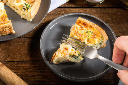 Classic salmon and broccoli quiche made from shortcrust pastry with broccoli florets and smoked salmon in a creamy free range egg custardの写真素材