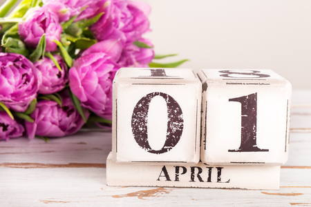 Wooden Block with Fools Day Date, 1 April, Purple Tulips nearbyの写真素材