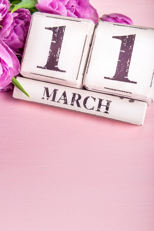 Wooden Blocks with Mothers Day Date, 11 March, for the year 2018, Purple Tulips nearbyの写真素材