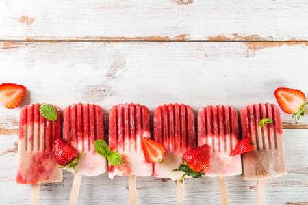 Homemade Vegan Strawberry ice cream from Strawberry Juice and Coconut Milk on light wooden background. Summer food concept. Top view.の写真素材