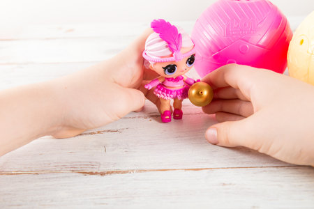 The girl is playing with L.O.L. Surprise Dollsのeditorial素材