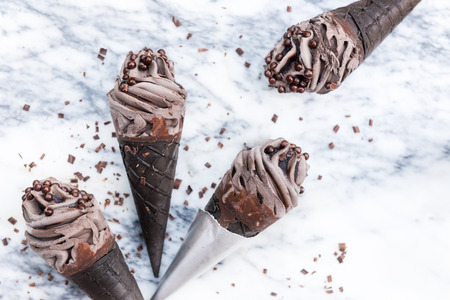 Double Chocolate Ice Creams with Black Waffle Cones on Marble Backgroundの写真素材