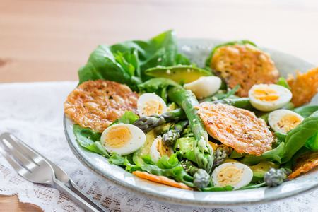 Asparagus Salad with quails eggs, avocado and cheese crisps, healthy detox lunchの写真素材