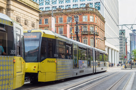 A tram on the Metrolink light rail system in the city centre ofのeditorial素材