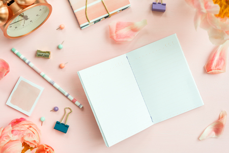 Empty Notebook for writing Dreams and Ideas, with different Stationery, and Big Pink Peony flowers laying on Pink background. Top View. Idea of Girly Office settings. Flat lay style.の写真素材