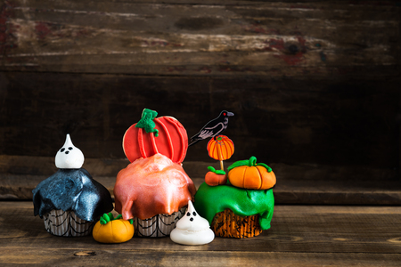 Table Set for Halloween Dinner with Scary Cupcakes and Cookiesの写真素材