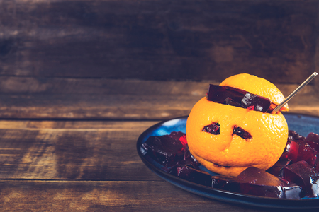 Kids Halloween Table set with Bloody Jelly, which is served inside the Orange with sad faceの写真素材