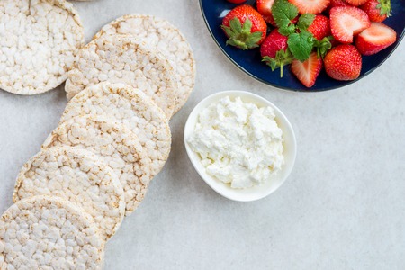 Healthy Snack from Rice Cakes with Ingredients nearby such as Ricotta Cheese and Strawberries on...