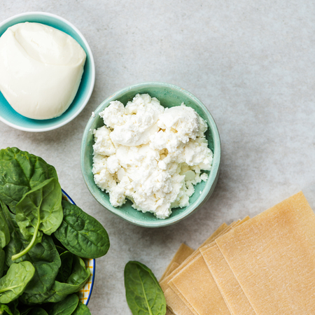 Ingredients for Vegetarian Spinach and Ricotta Lasagna, top view, grey backgroundの写真素材