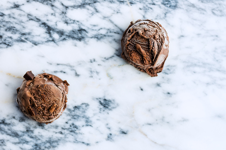 Chocolate ice cream scoops on marble background, top viewの写真素材