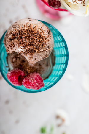 Plastic Ice Cream Sundae Cones with Chocolate and Vanilla Ice Cream Scoops and berriesの写真素材