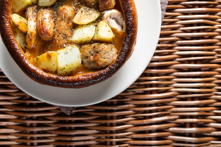 Open Pie with Potatoes and different kinds of meat on rustic background