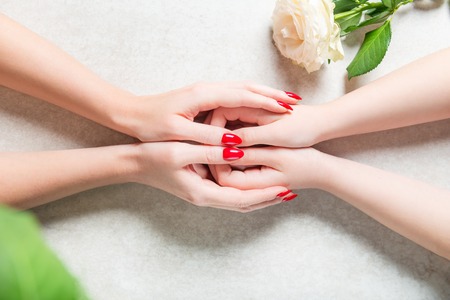Mother is holding her kids hands and showing her protection and family support, mothers day or relationship conceptの写真素材