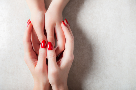 Mother is holding her kids hands and showing her protection and family support, mothers day or relationship conceptの写真素材