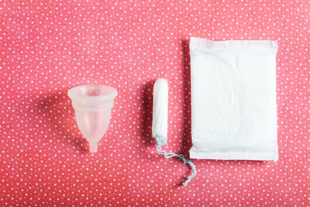 Hygiene items for womens critical days, such as pad, menstrual cup, tampon. Top view, flat lay, concept of womens health issuesの写真素材